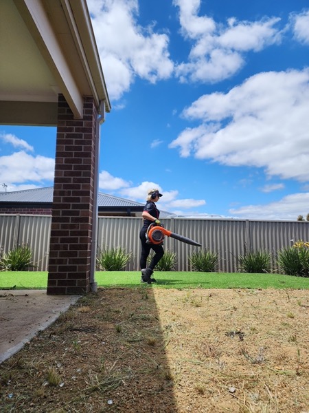 Blowing down a freshly cut lawn at the end of a job