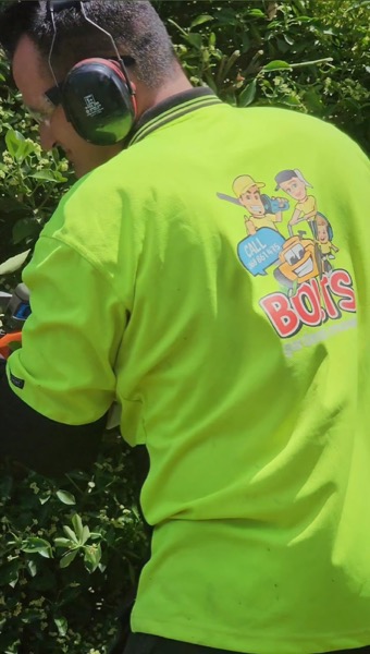 A Bolt’s Gardening and Mowing branded work shirt on the job