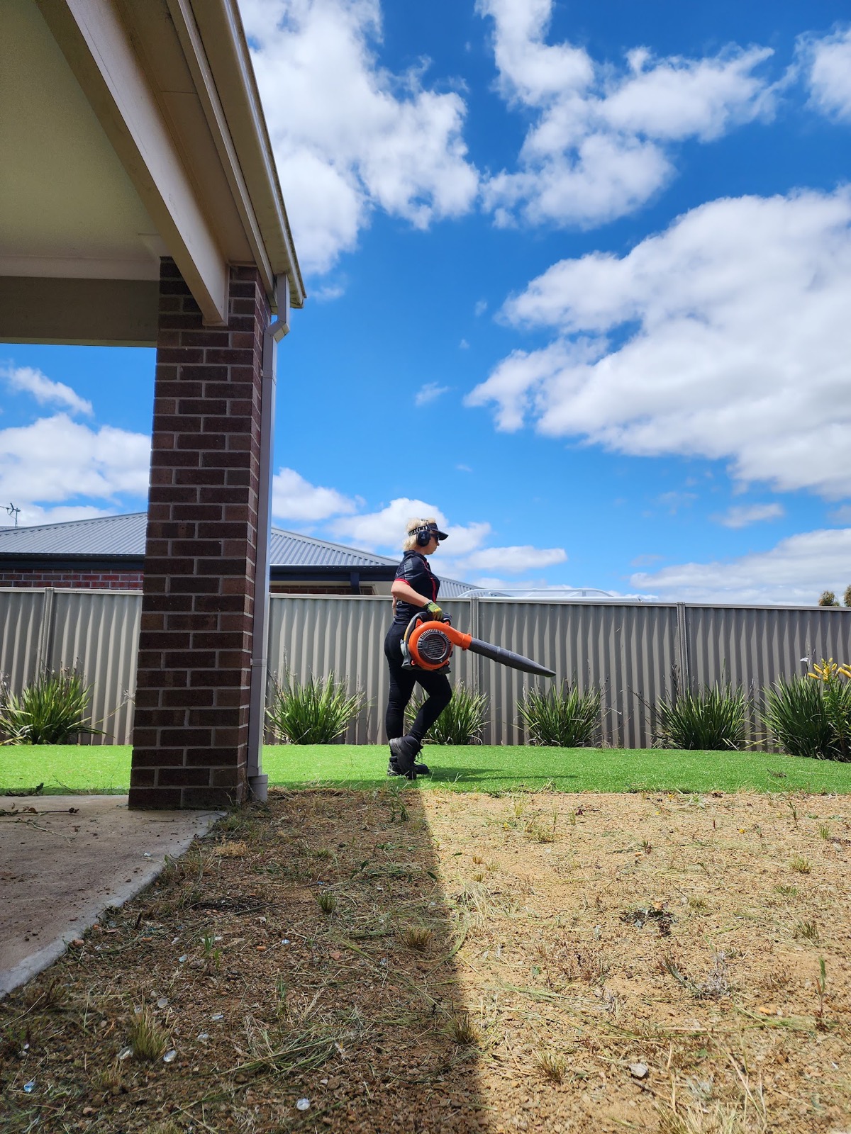Blowing down a freshly cut lawn at the end of a job